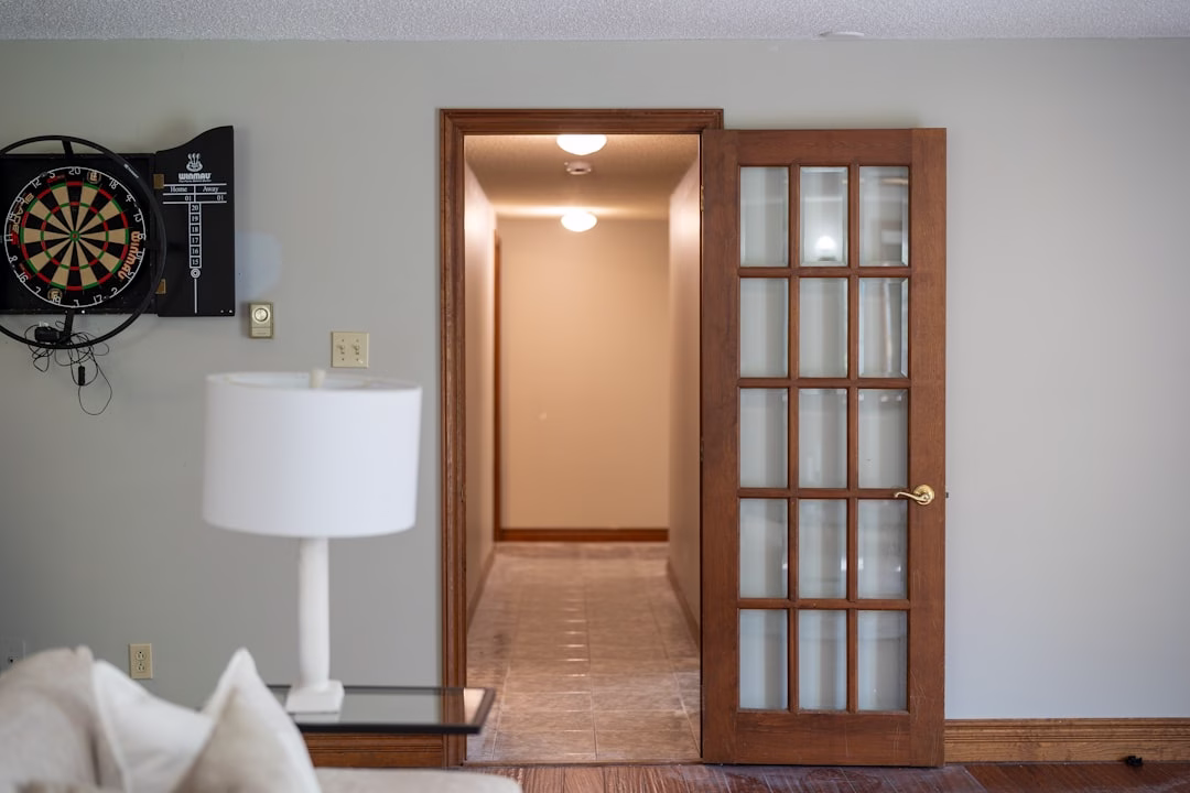 Interior glass-paneled door in a bright hallway